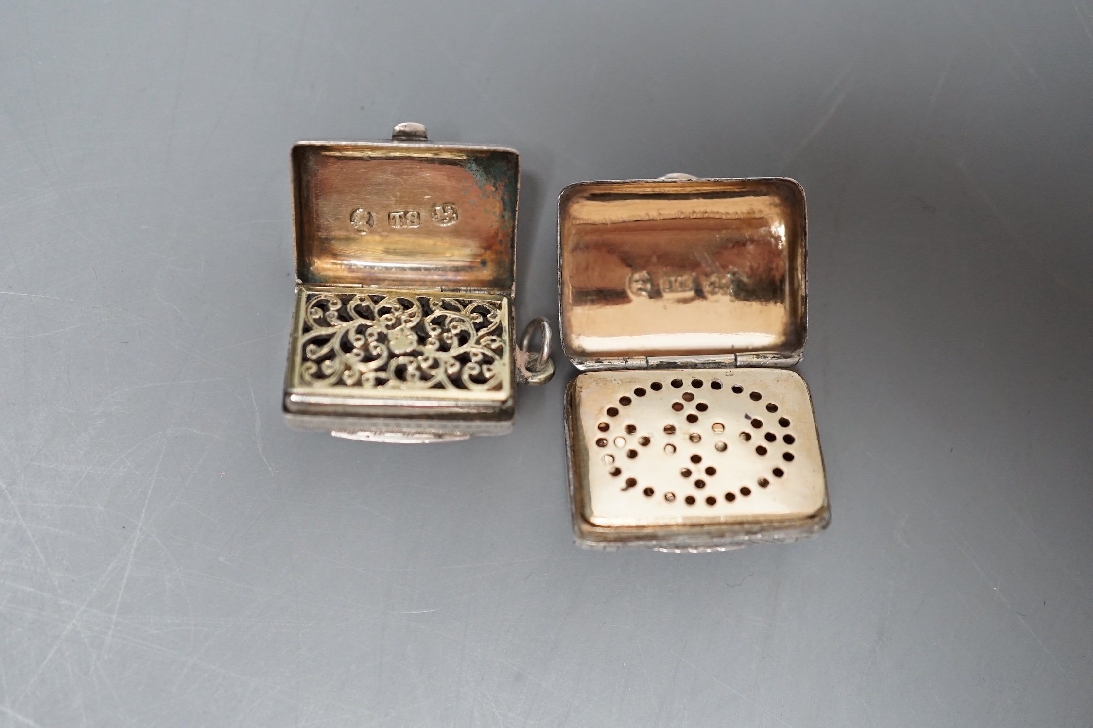A George III engraved silver vinaigrette, modelled as a handbag, John Lawrence & Co, Birmingham, 1817, 23mm engraved 'Anne' and a similar William IV silver vinaigrette, Thomas Simpson Jn, Birmingham, 1831, 21mm.